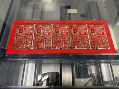 Finished PCB assemblies coming out of the BTU International Reflow Oven.