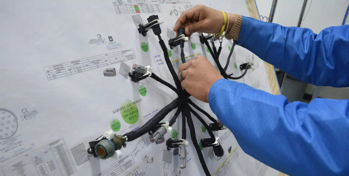PGF Team building a wire harness assembly
