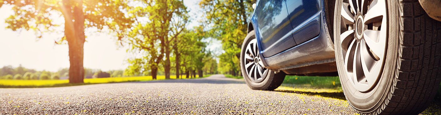 Car on asphalt road in summer