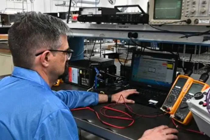 PGF employee using in-circuit testing on PCBA