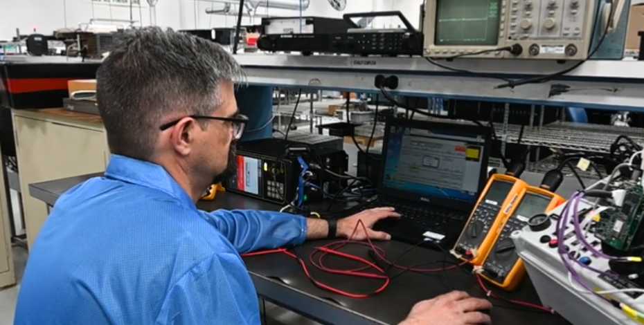 PGF employee using in-circuit testing on PCBA