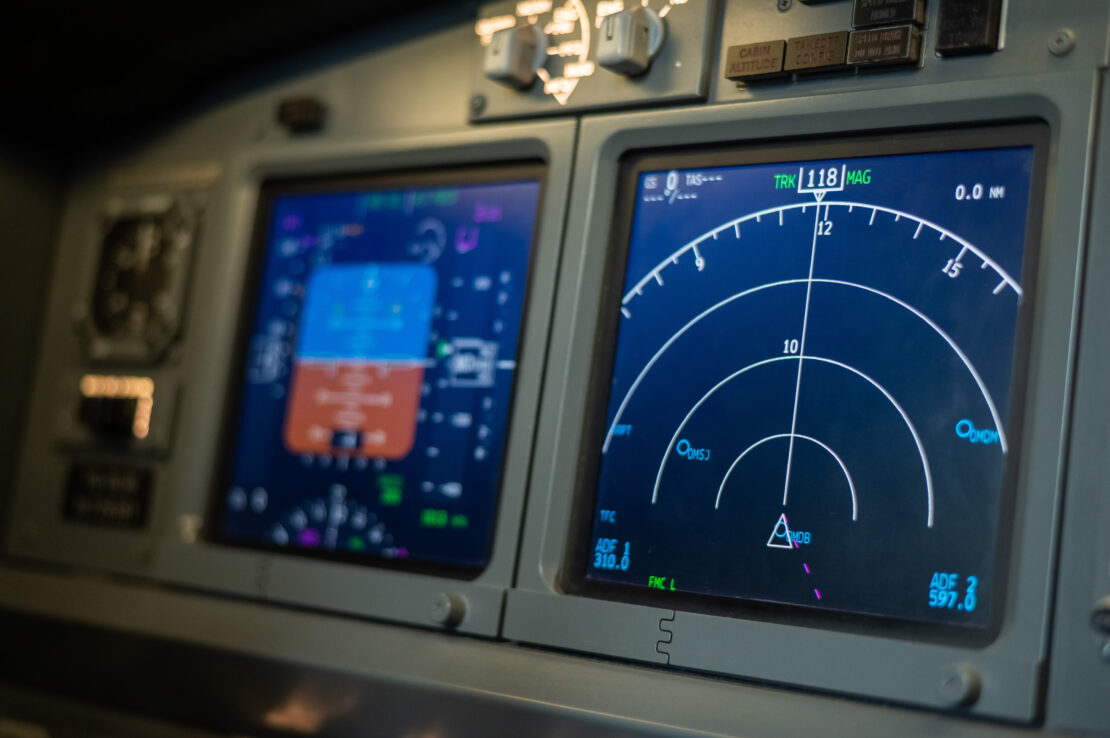 A close-up of an airplane's navigation system dashboard.
